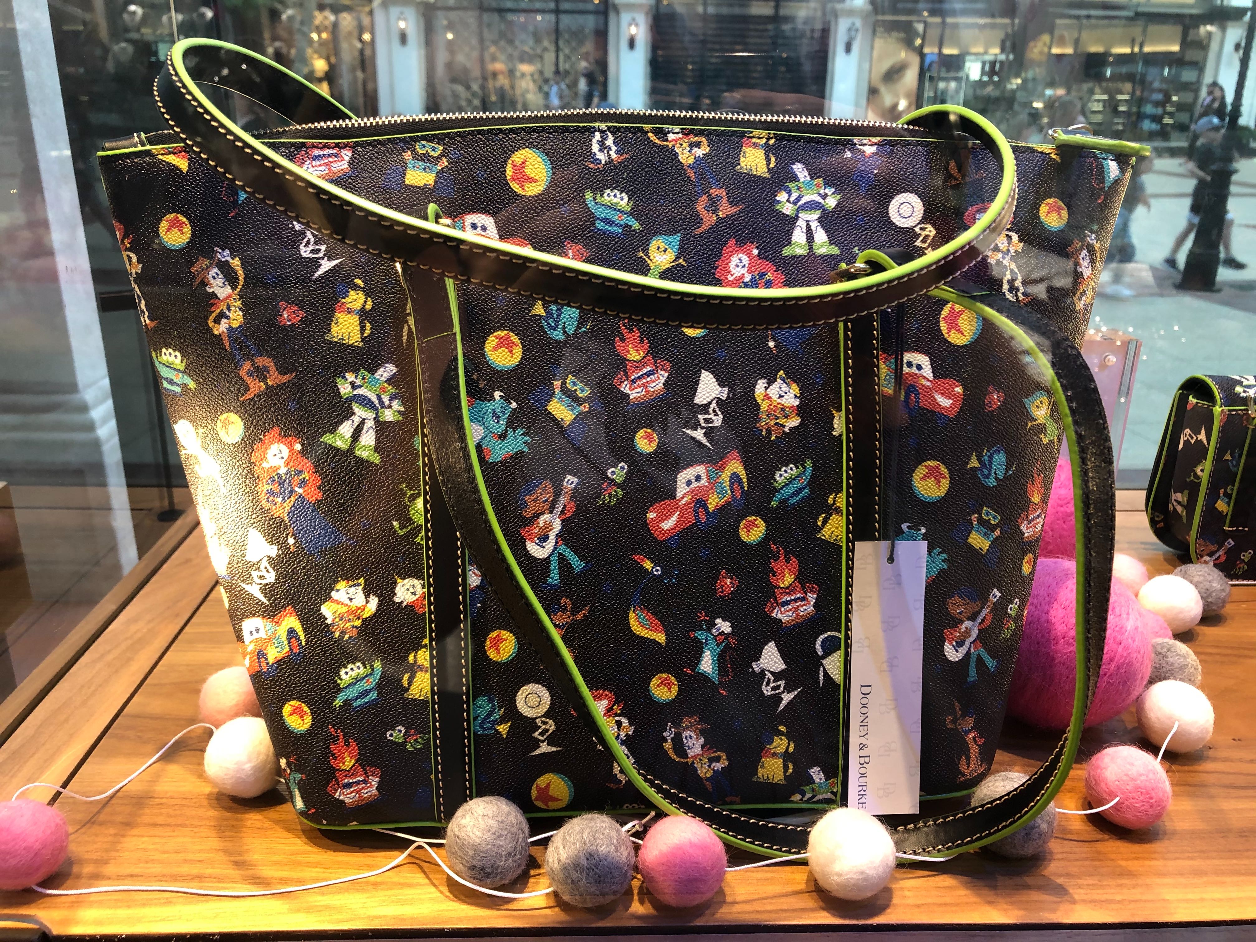 PHOTOS New “World of PIXAR” Dooney & Bourke Collection Coming Soon to