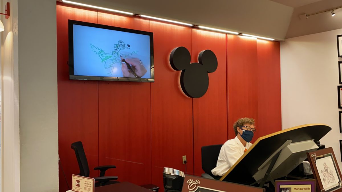 Artist drawing art of Disney Disney springs